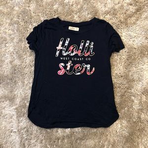 dark blue Hollister tee with flowered lettering